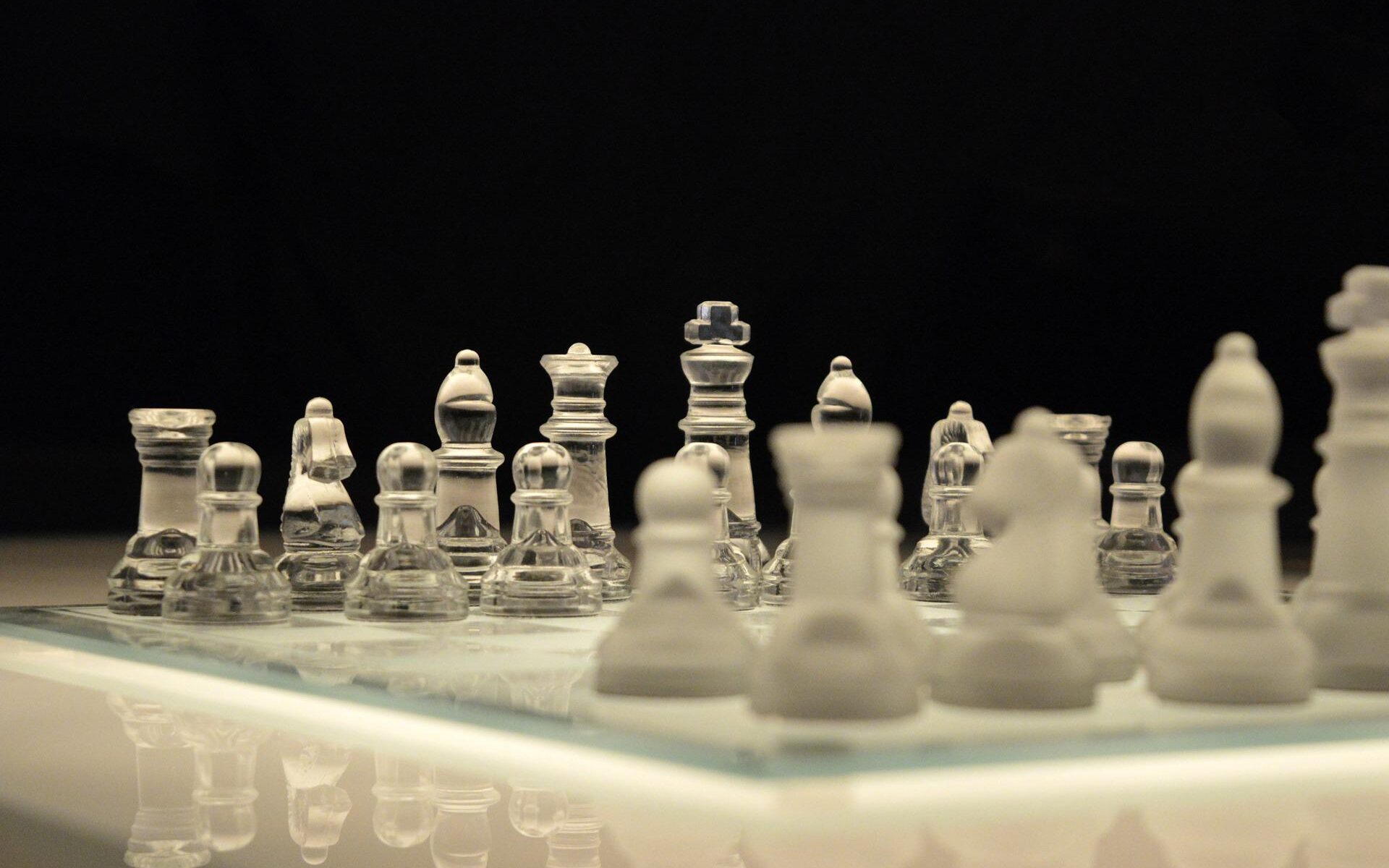 A clear and frosted glass chessboard